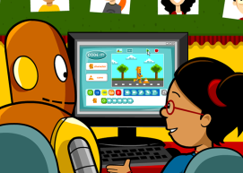 Moby and Annie in front of a computer with a coding game open