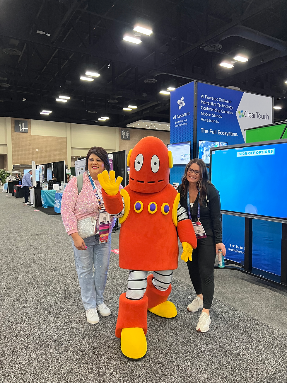 Lifesize Moby mascot posing with two teachers at an event