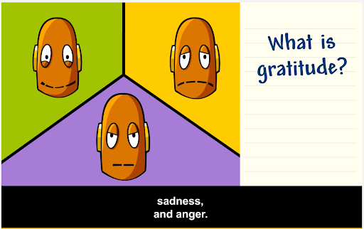 Three orange cartoon robot heads with varying expressions on green, yellow, and purple backgrounds. On-screen text: "What is gratitude? Subtitles are paused at a quote including "sadness, and anger." From Emotions BrainPOP Jr. movie.
