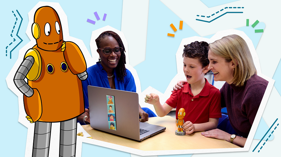 Moby the orange robot stands beside a happy group at a laptop. Woman, boy, and another woman engage with a small robot toy, blue backdrop.